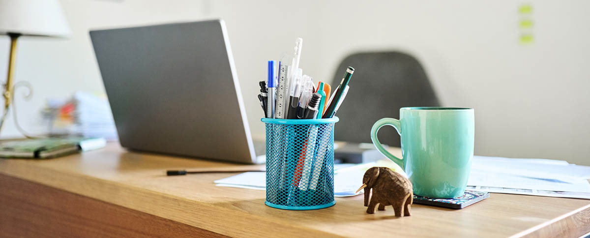 Decorative image of a desk with pens